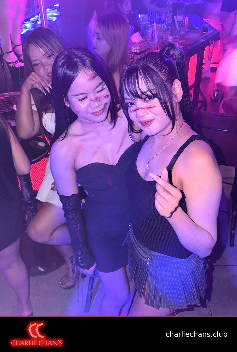Three team members in Halloween makeup posing together at the bar