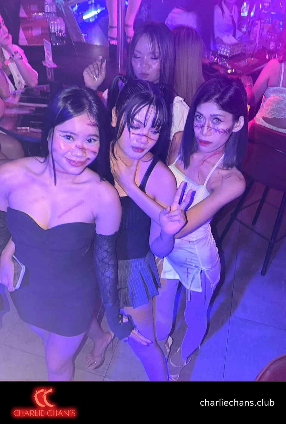 Four team members showing their Halloween makeup at Charlie Chan's Club