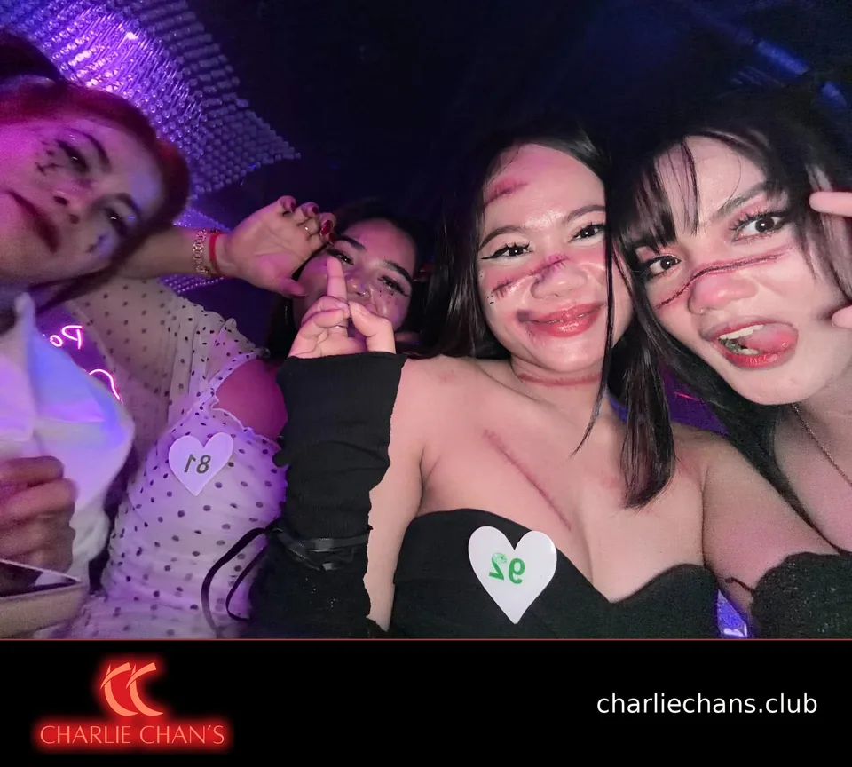 Four team members taking a close Halloween group selfie