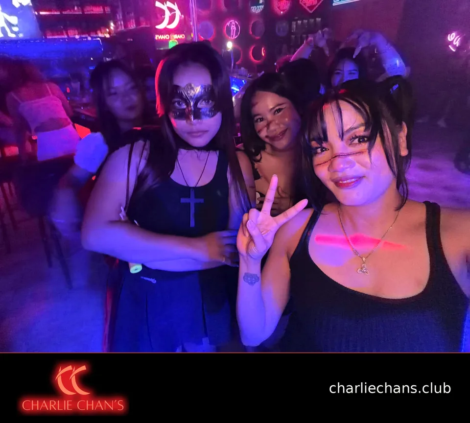 Team members in a masquerade mask and Halloween makeup posing together