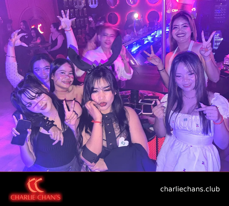 A group of team members gathered around a table in Halloween costumes