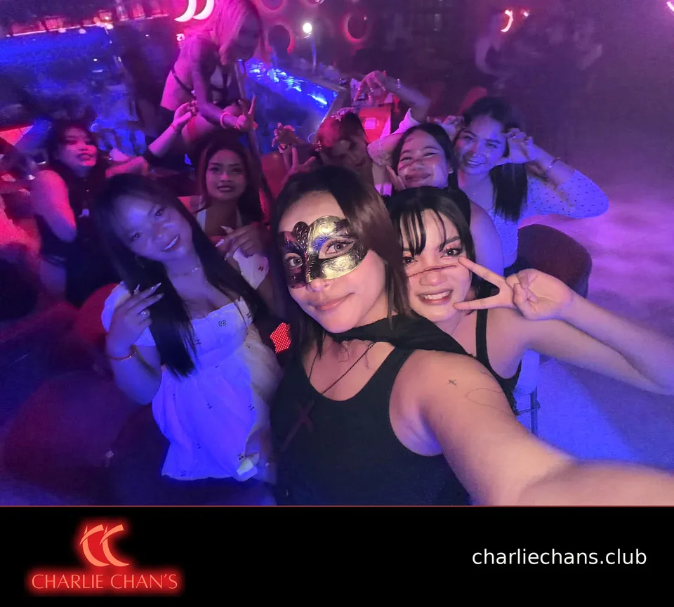 A lively Halloween group selfie on the club floor