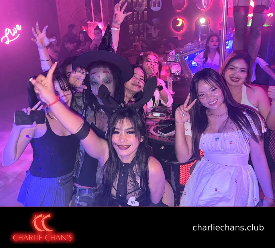 A Halloween group pose with witch, clown and stitched-makeup costumes